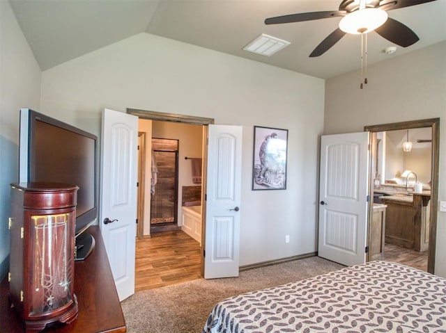 2216 Wheatheart Dr, Yukon, OK 73099 - bedroom featuring vaulted ceiling, light colored carpet, connected bathroom, and visible vents