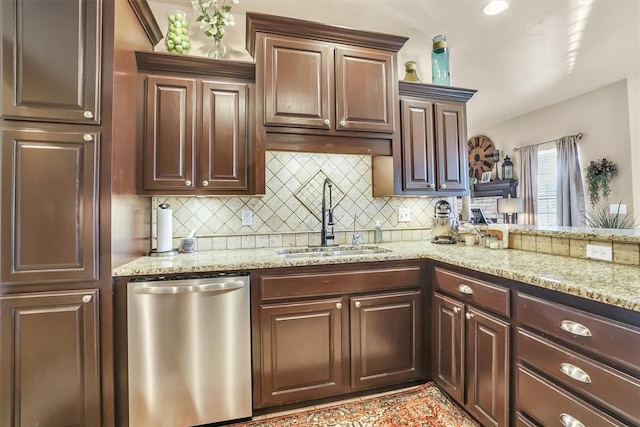 kitchen with decorative backsplash, stainless steel dishwasher, light stone countertops, dark brown cabinets, and a sink