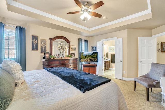 bedroom with crown molding, baseboards, light carpet, and a raised ceiling