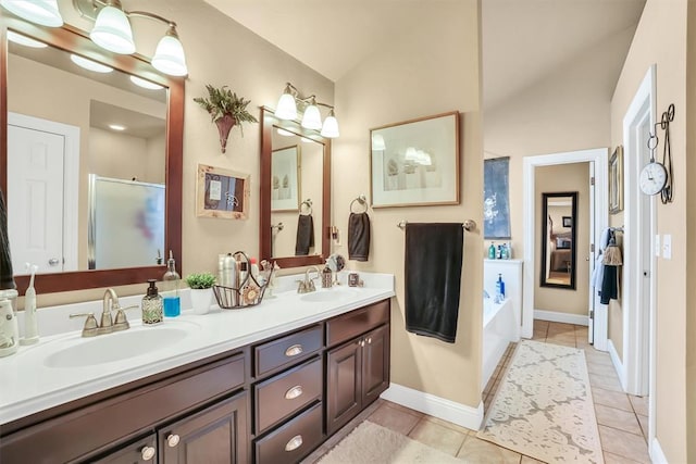 bathroom with double vanity, a sink, lofted ceiling, and a stall shower