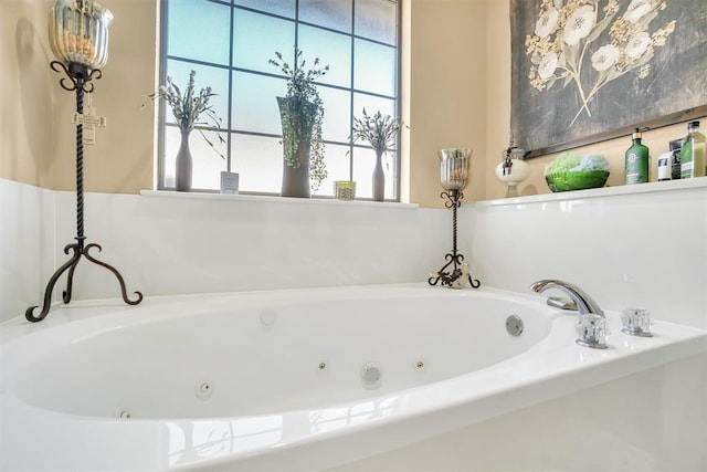 full bathroom featuring a tub with jets and a wealth of natural light