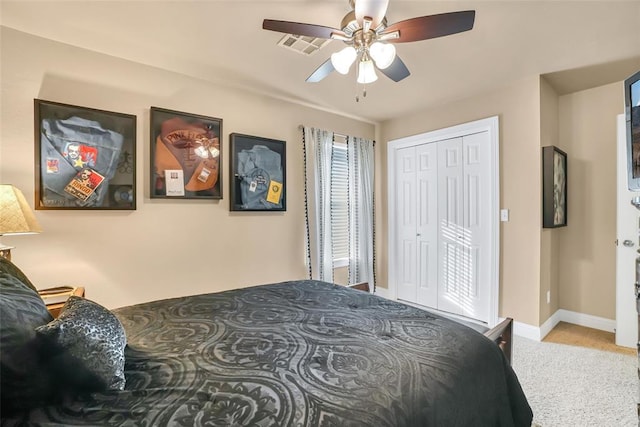 carpeted bedroom with baseboards, a ceiling fan, and a closet
