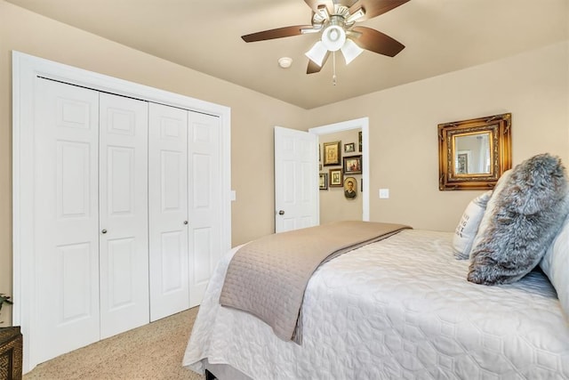 carpeted bedroom featuring ceiling fan and a closet