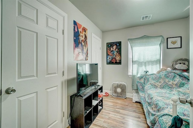 interior space with visible vents, baseboards, and wood finished floors