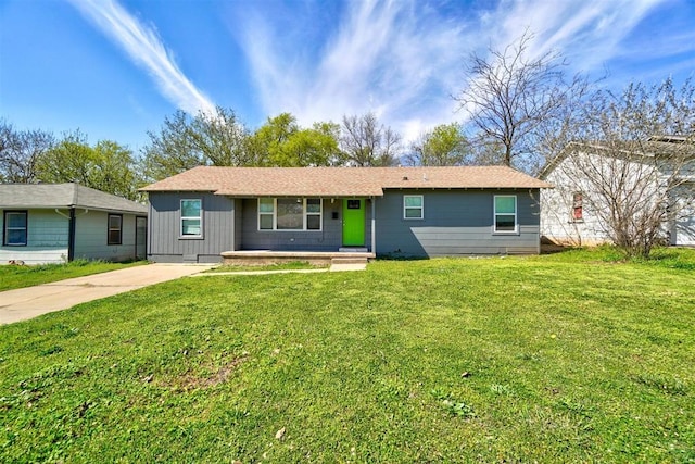 single story home featuring concrete driveway and a front lawn