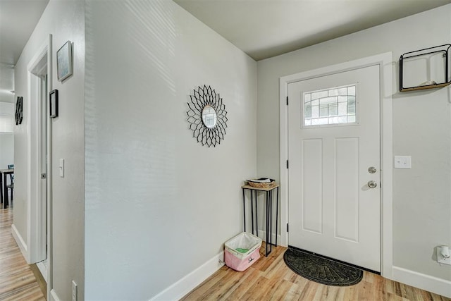 foyer entrance featuring light wood-type flooring and baseboards