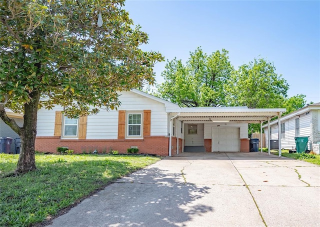 view of front of home featuring a front lawn, a garage, a carport, brick siding, and concrete driveway