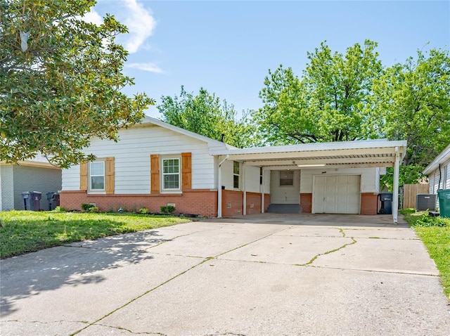 single story home featuring brick siding, a carport, and driveway