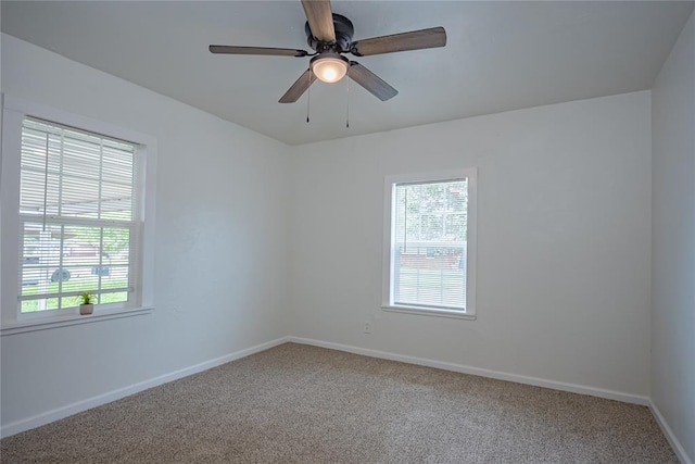 unfurnished room with baseboards, a ceiling fan, and carpet floors