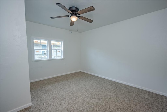 empty room with baseboards, ceiling fan, and carpet