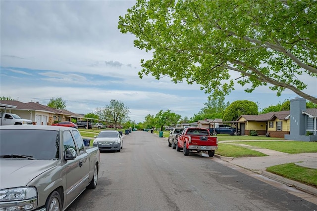 view of street featuring curbs and a residential view