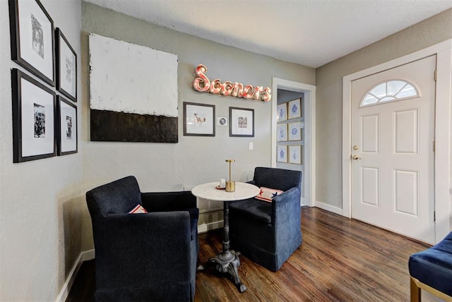 interior space with baseboards and wood finished floors