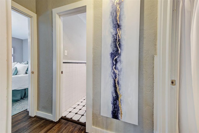 bathroom featuring ensuite bathroom, wood finished floors, and a textured wall
