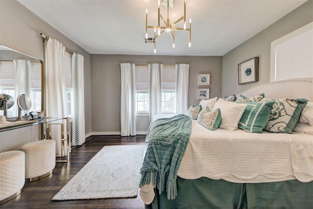bedroom featuring an inviting chandelier, baseboards, visible vents, and dark wood finished floors