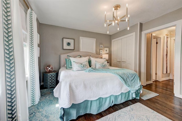 bedroom with a notable chandelier, a closet, and wood finished floors