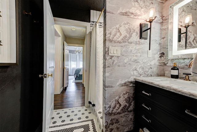 ensuite bathroom featuring vanity, ensuite bath, and tile patterned flooring