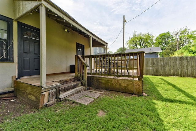 exterior space featuring a lawn and fence