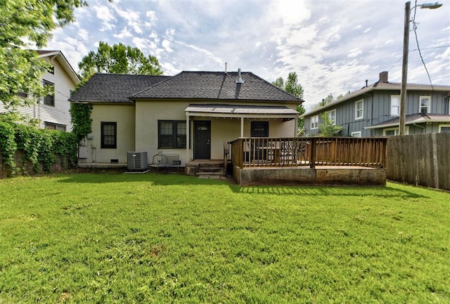 back of house featuring a yard, stucco siding, and a fenced backyard