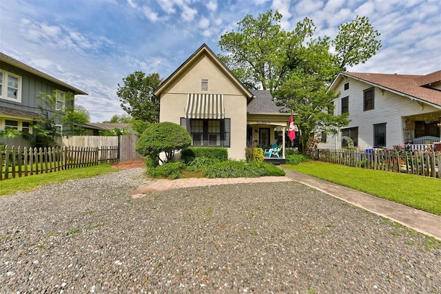 bungalow-style home with fence and stucco siding