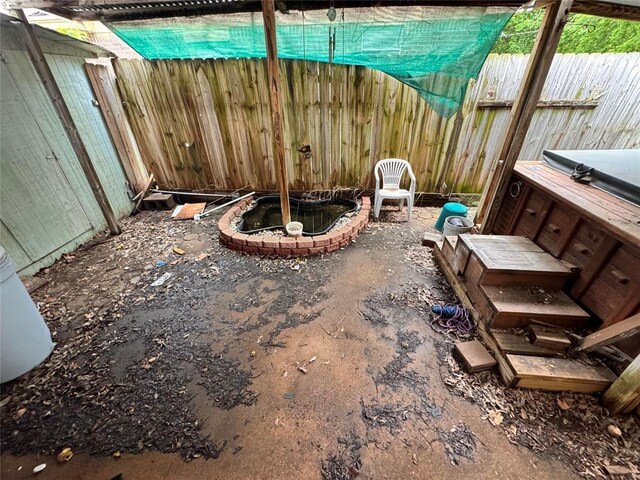 exterior space featuring fence and a hot tub