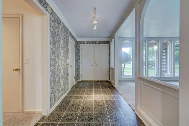 hall featuring crown molding, baseboards, and wallpapered walls