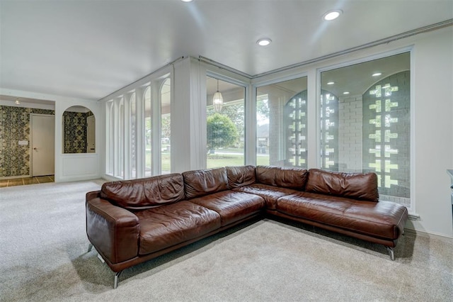living room featuring arched walkways, plenty of natural light, carpet, and recessed lighting