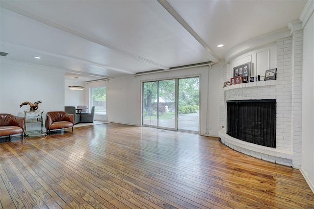 living area with visible vents, a fireplace, beamed ceiling, recessed lighting, and hardwood / wood-style flooring