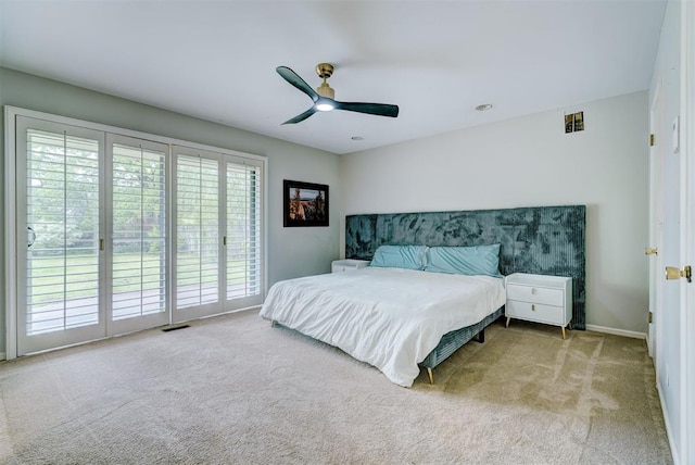 carpeted bedroom featuring access to outside, baseboards, ceiling fan, and visible vents