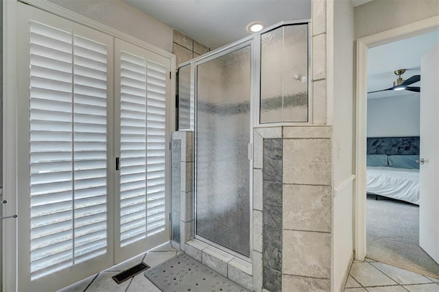 full bath with a ceiling fan, visible vents, tile patterned flooring, a shower stall, and ensuite bath