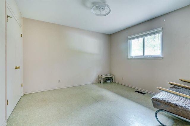 spare room with baseboards and visible vents