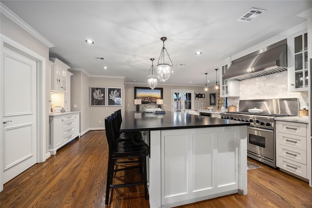 1119 Glenwood Ave, Nichols Hills, OK 73116 - kitchen with wall chimney exhaust hood, visible vents, ornamental molding, high end stainless steel range oven, and white cabinets