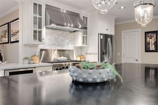 1119 Glenwood Ave, Nichols Hills, OK 73116 - kitchen featuring wall chimney range hood, white cabinetry, crown molding, a chandelier, and stainless steel refrigerator with ice dispenser