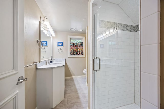 1119 Glenwood Ave, Nichols Hills, OK 73116 - bathroom featuring a shower stall, toilet, vanity, baseboards, and visible vents