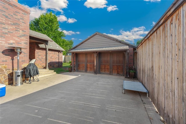 1119 Glenwood Ave, Nichols Hills, OK 73116 - view of patio with a detached garage and an outbuilding