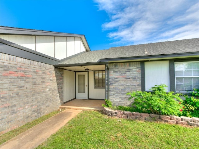 1357 W Cedarbrook Ln, Moore, OK 73170 - property entrance with a lawn and roof with shingles