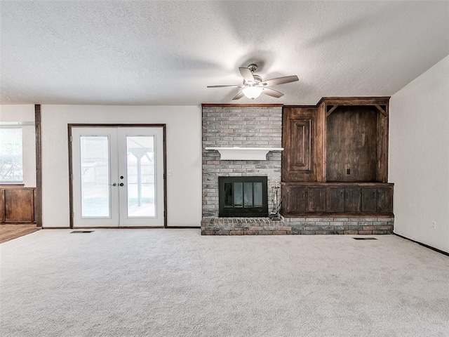 1357 W Cedarbrook Ln, Moore, OK 73170 - unfurnished living room featuring a wealth of natural light, ceiling fan, a textured ceiling, and carpet