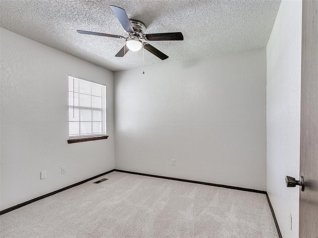 1357 W Cedarbrook Ln, Moore, OK 73170 - carpeted spare room featuring baseboards, visible vents, ceiling fan, and a textured ceiling