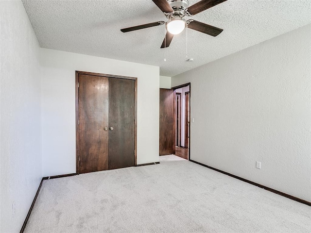 1357 W Cedarbrook Ln, Moore, OK 73170 - unfurnished bedroom featuring a closet, carpet flooring, ceiling fan, and a textured ceiling