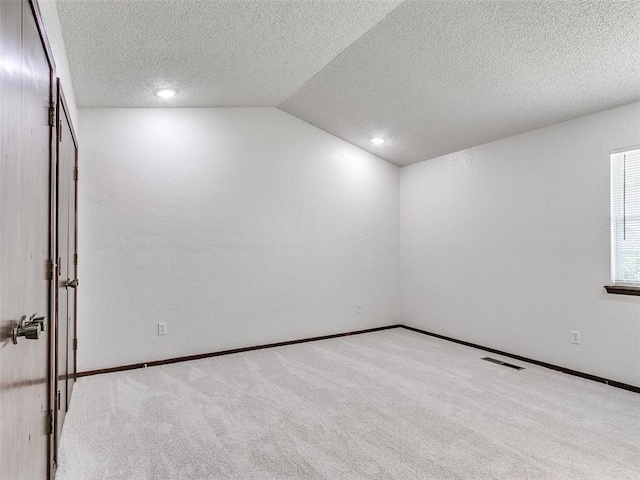 1357 W Cedarbrook Ln, Moore, OK 73170 - carpeted empty room with visible vents, a textured ceiling, lofted ceiling, and recessed lighting