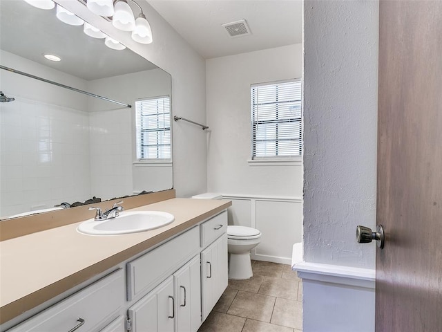 1357 W Cedarbrook Ln, Moore, OK 73170 - full bath with toilet, visible vents, tile patterned floors, and a healthy amount of sunlight