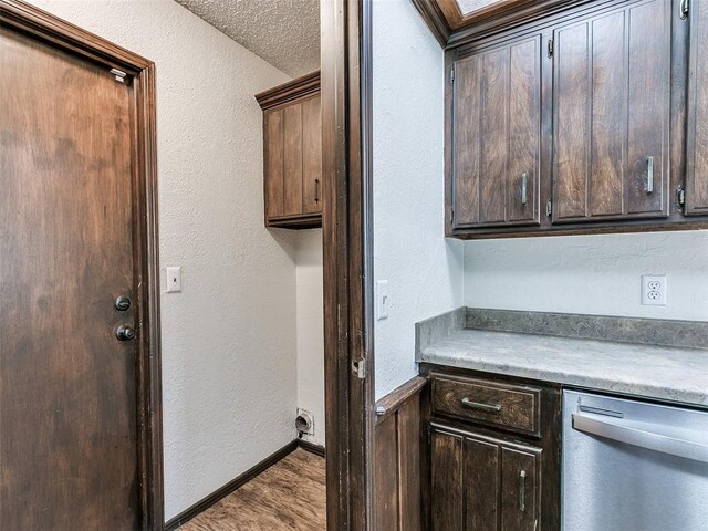 1357 W Cedarbrook Ln, Moore, OK 73170 - kitchen featuring dishwasher, a textured wall, dark brown cabinets, and wood finished floors
