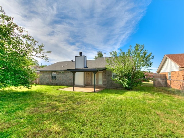 1357 W Cedarbrook Ln, Moore, OK 73170 - rear view of property with fence, a chimney, a yard, and a patio