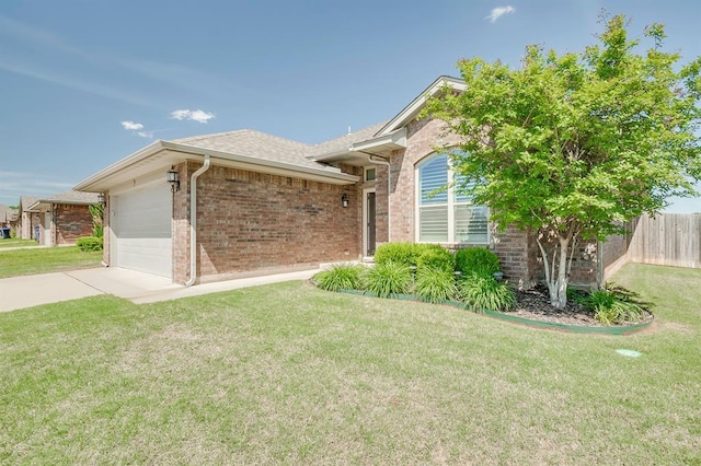 ranch-style home with brick siding, an attached garage, driveway, and a front yard
