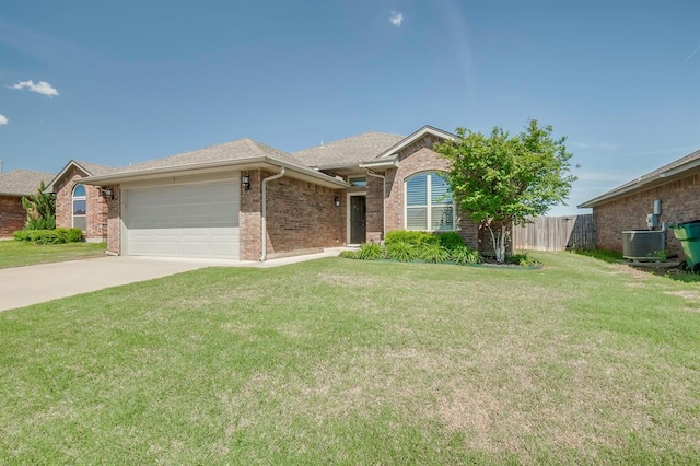 ranch-style house with a garage, fence, a front yard, brick siding, and concrete driveway
