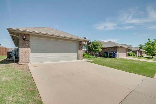 view of front of house featuring a front lawn, brick siding, a garage, central AC unit, and concrete driveway