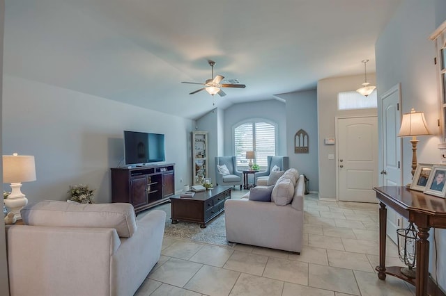 living room with ceiling fan, lofted ceiling, and light tile patterned floors