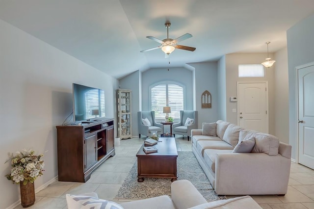 living area with baseboards, ceiling fan, lofted ceiling, and light tile patterned flooring