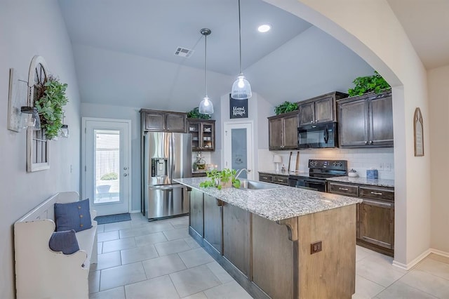 kitchen with visible vents, a sink, black appliances, lofted ceiling, and light tile patterned flooring