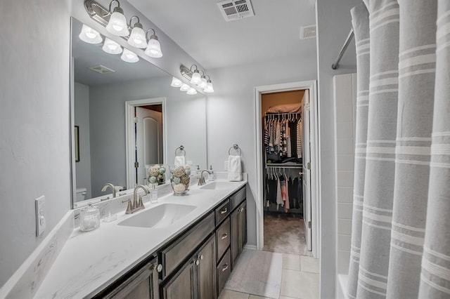 full bath with visible vents, a sink, a shower with shower curtain, and tile patterned floors