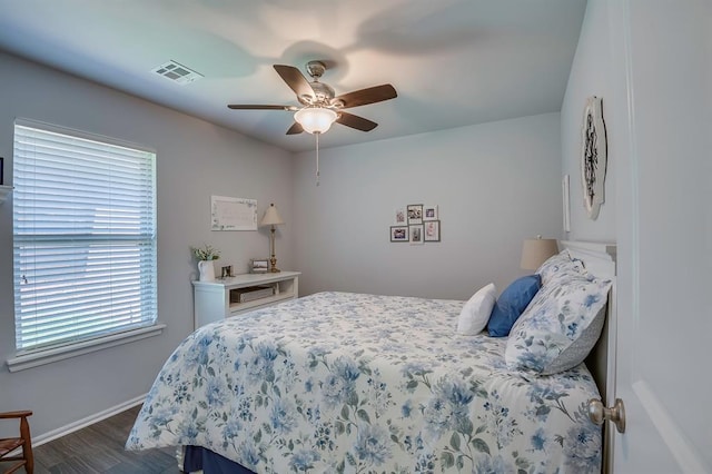 bedroom featuring baseboards, multiple windows, dark wood-style flooring, and visible vents